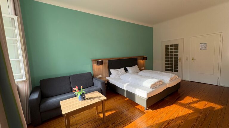 Family room with double bed, sofa and coffee table
